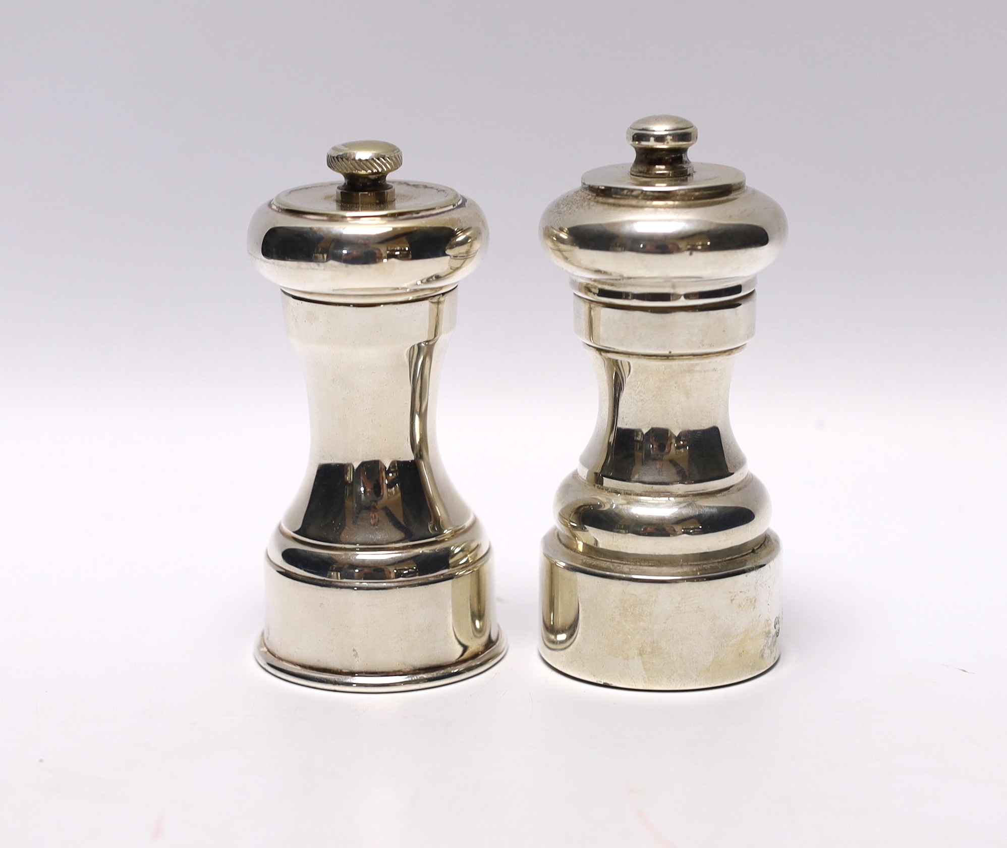A 1970's silver mounted pepper mill, Da-Mar Silverware, London, 1977, 10.6cm, together with a silver plated pepper mill.